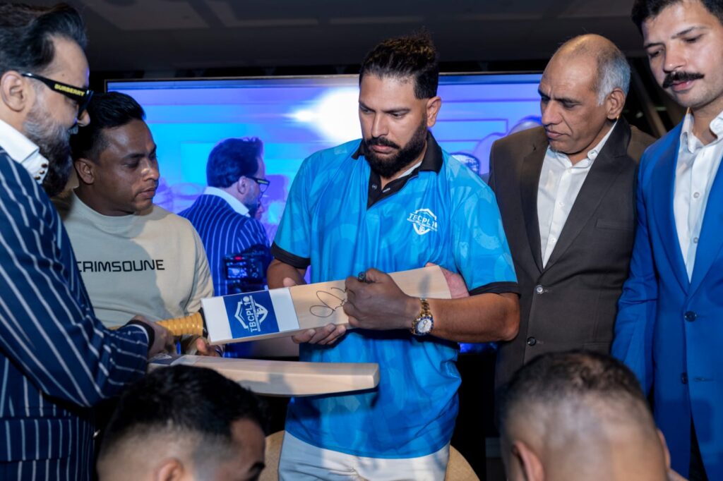 Yuvraj Singh signs a bat to launch the inaugural Tennis Ball Cricket Premier League 10 (TBCPL) at the kickoff event in Dubai on Monday, Jan 6 with promoter Naresh Pawar and key stakeholder Mohit Joon looking on.