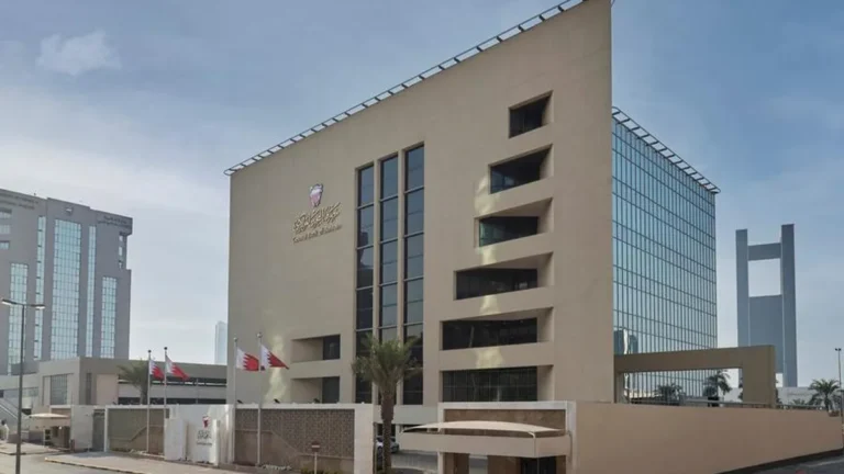 Bahrain Central Bank building with financial data overlay.