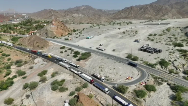 Dubai Police officers monitoring truck traffic on Hatta Road.