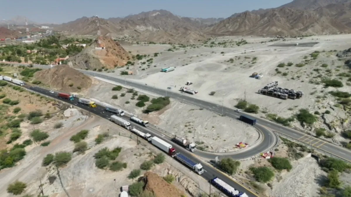 Dubai Police officers monitoring truck traffic on Hatta Road.