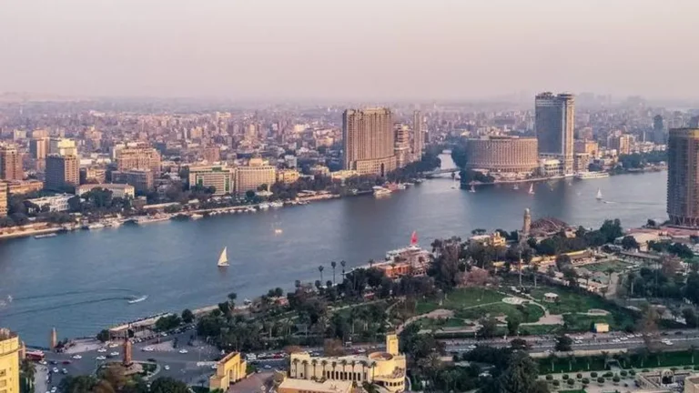 Cairo skyline with modern buildings and traffic, representing Egypt's economy.