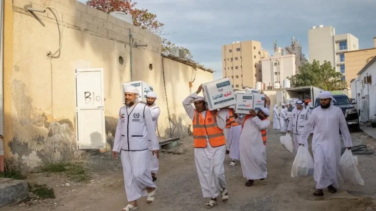 Volunteers distributing food packages during the Eid Al-Adha campaign.