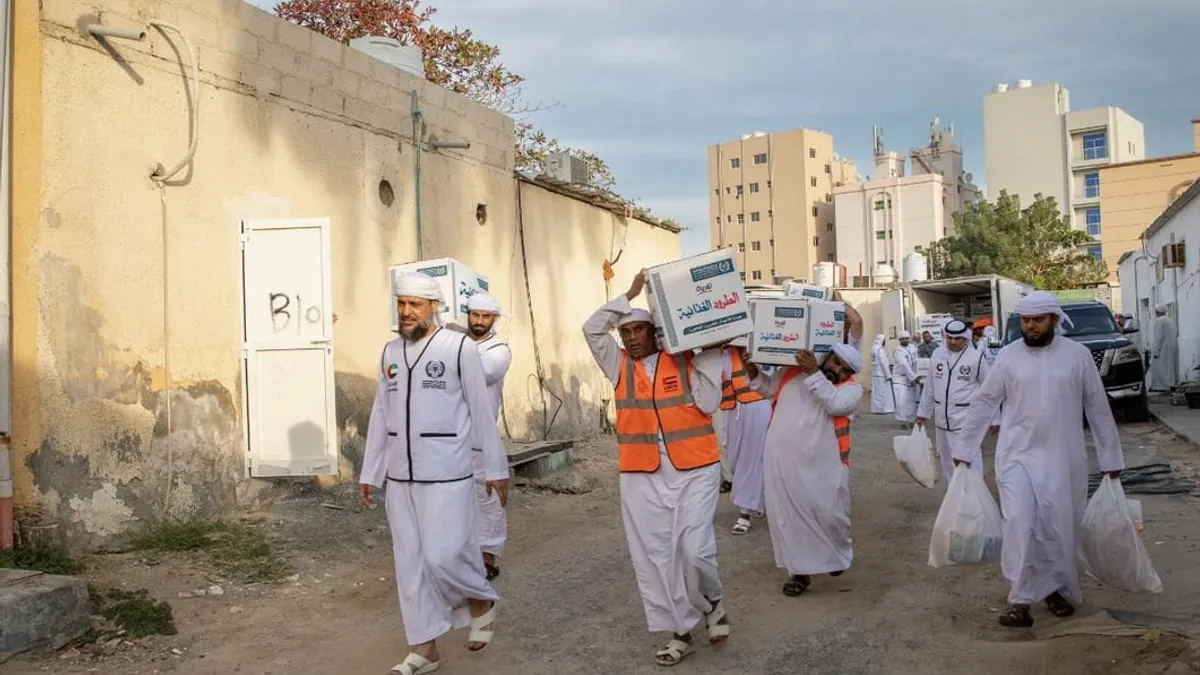 Volunteers distributing food packages during the Eid Al-Adha campaign.