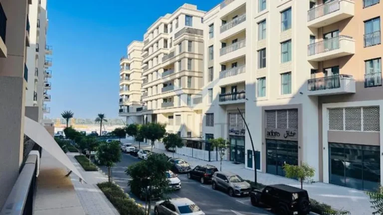 Furnished studio apartment in Sharjah's Nadi Residences with balcony.