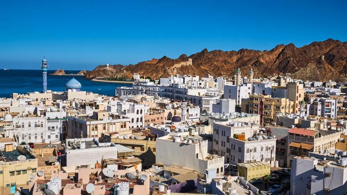 Aerial view of Greater Muscat showcasing urban development and planning.