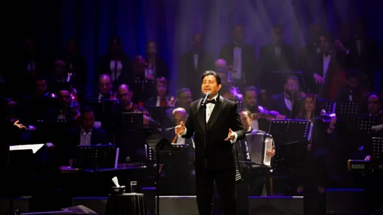 Hani Shaker performing on stage during a concert.