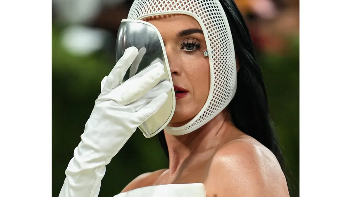 Katy Perry at the 2026 Met Gala wearing a dramatic masked outfit.