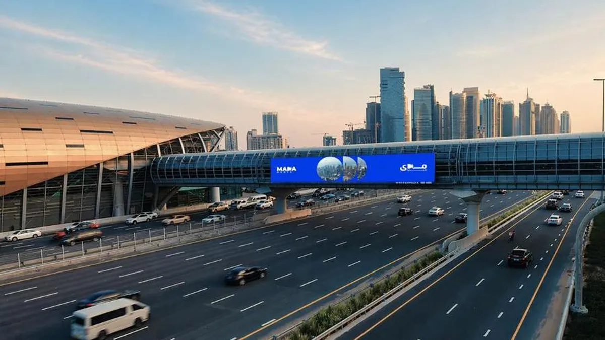Dubai skyline featuring out-of-home advertising displays.