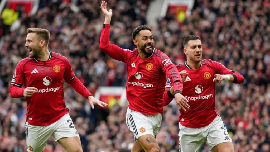 Manchester United players celebrating their return to the Champions League.