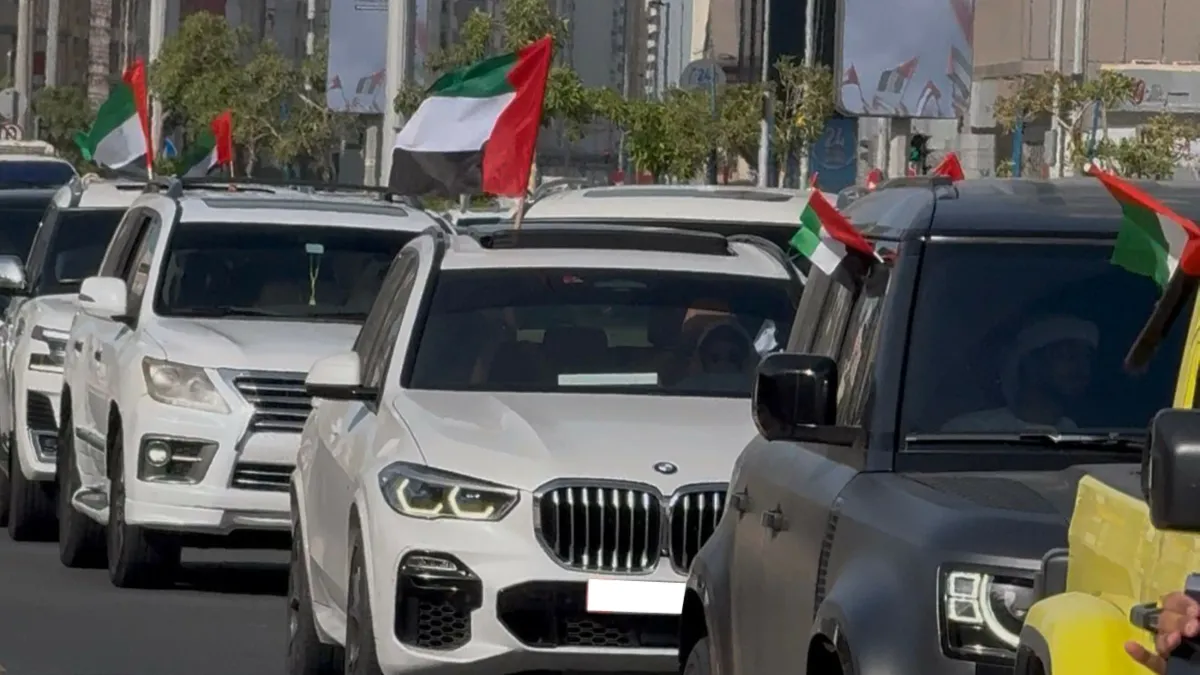 Participants waving UAE flags during the March of Pride event in Abu Dhabi.