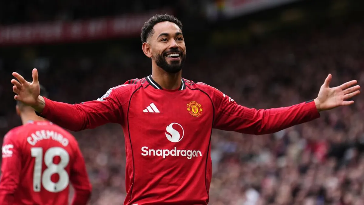 Matheus Cunha celebrating a goal at Old Trafford during a Premier League match.