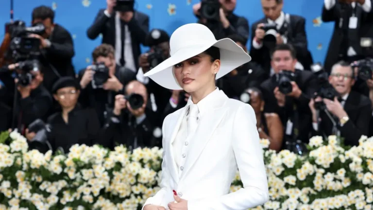 Glamorous attendees at the Met Gala showcasing custom fashion designs.