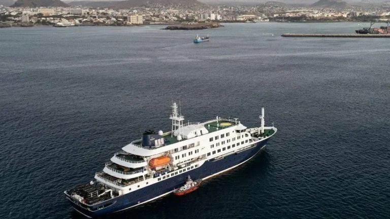 Caribbean Princess cruise ship at sea with passengers on deck.