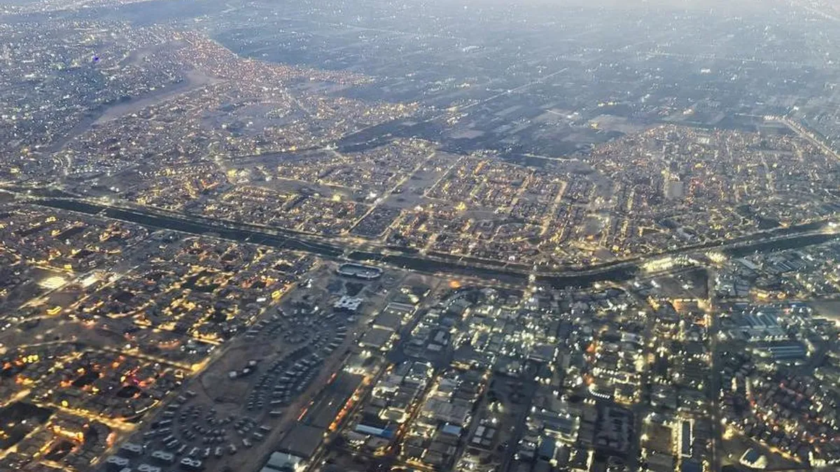 Aerial view of Cairo's traffic and buildings from a plane window.