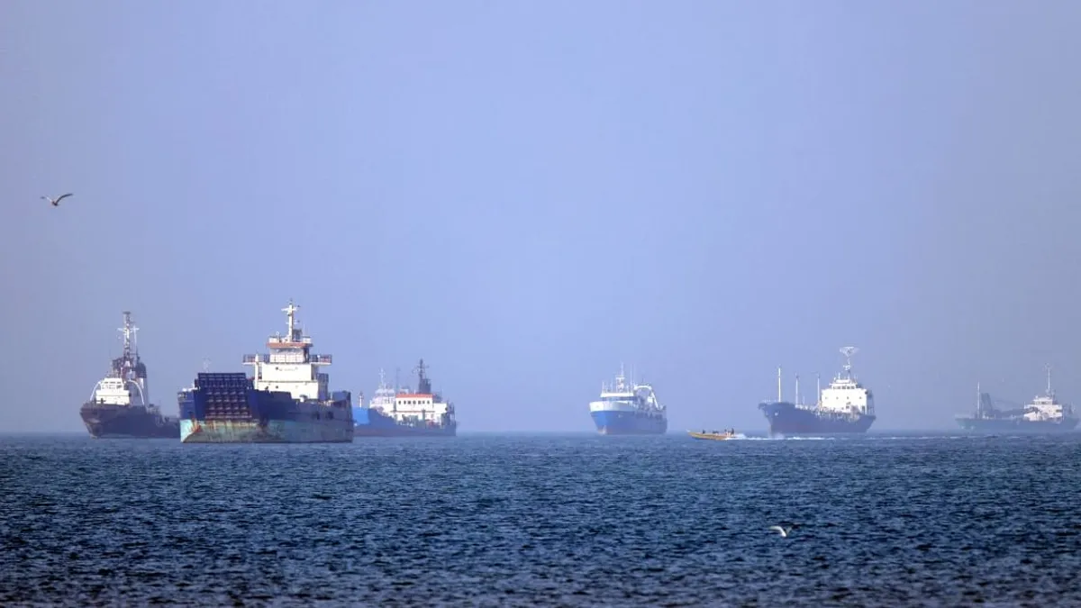 Oil tankers navigating the Strait of Hormuz with a backdrop of geopolitical tensions.