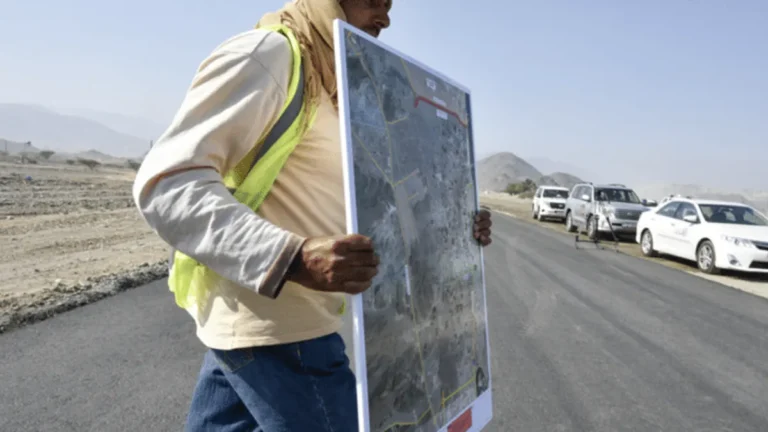 Construction workers in Oman during summer heat with safety measures.