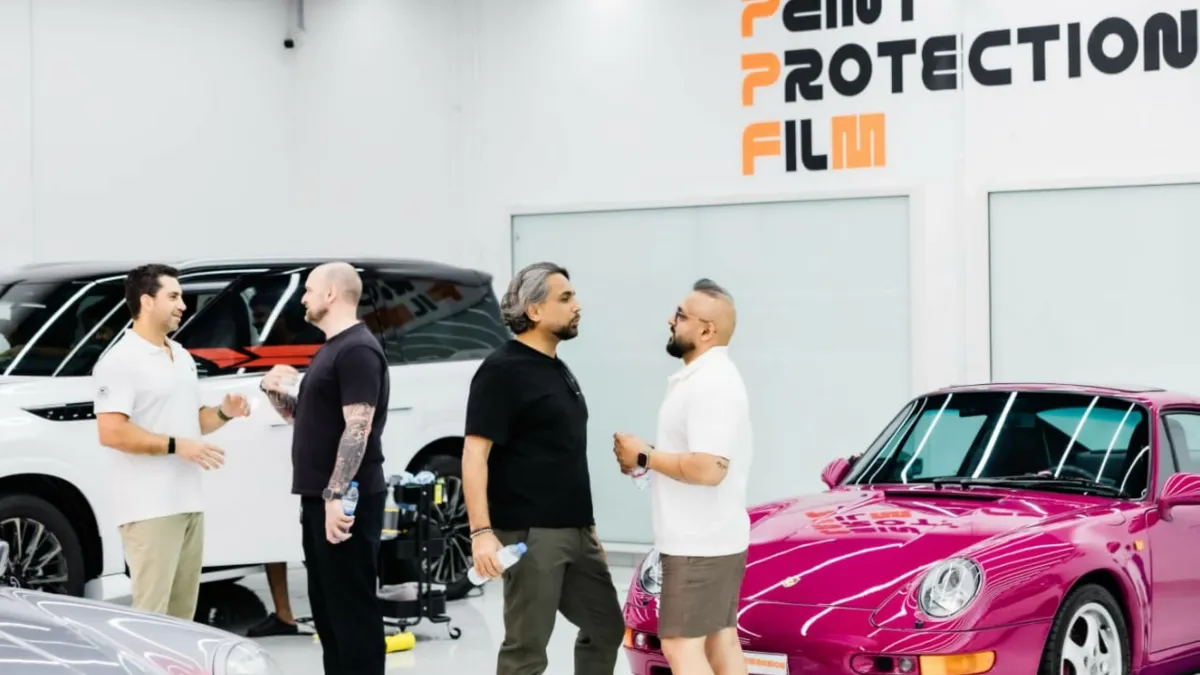 Community gathering at Performansion's luxury automotive showroom in Dubai.