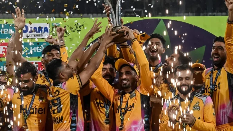 Babar Azam celebrating with the PSL trophy after Peshawar Zalmi's victory.
