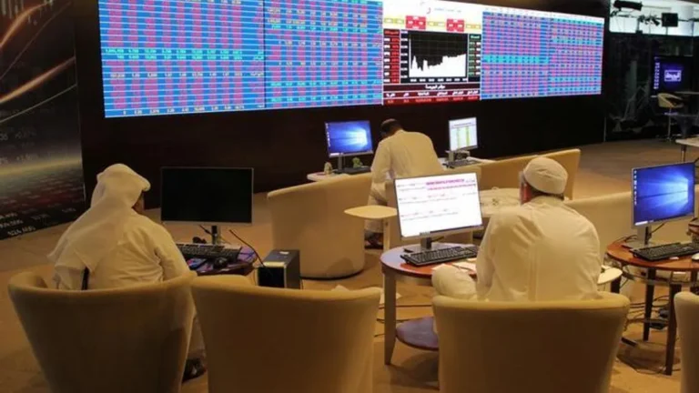 Qatar Stock Exchange trading floor with active market activity.