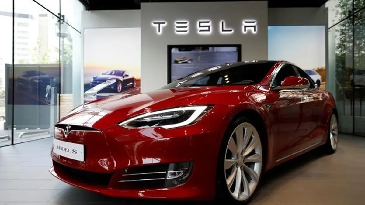 Tesla store in Dubai showcasing electric vehicles and job opportunities.