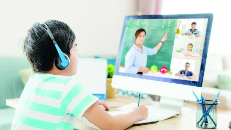Students attending a virtual class via computer at home.