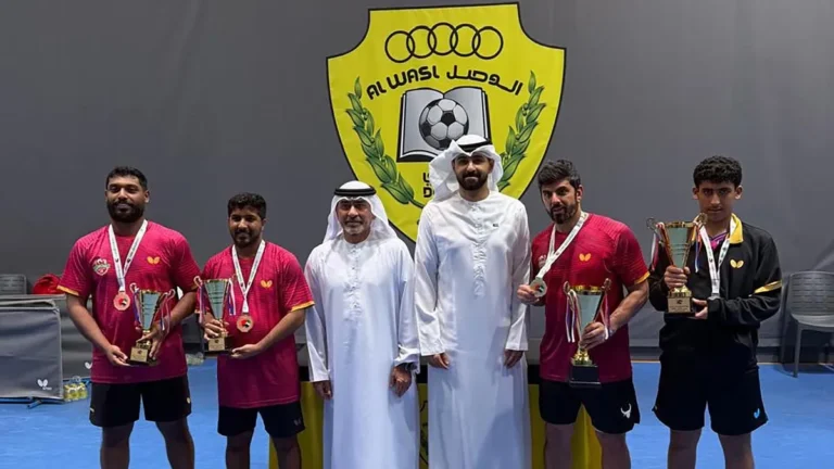 UAE table tennis players receiving medals at a competition ceremony.