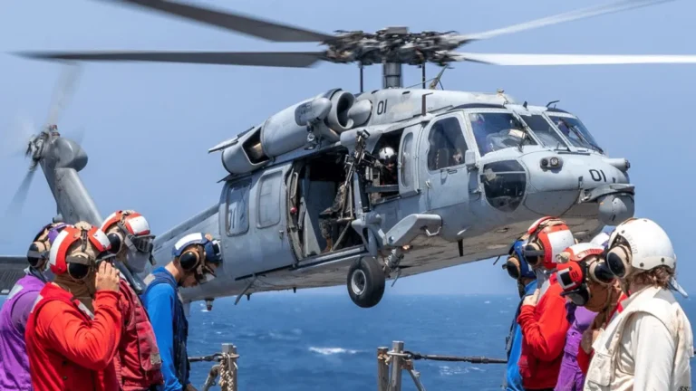 US Navy ships navigating the Strait of Hormuz amidst rising tensions with Iran.